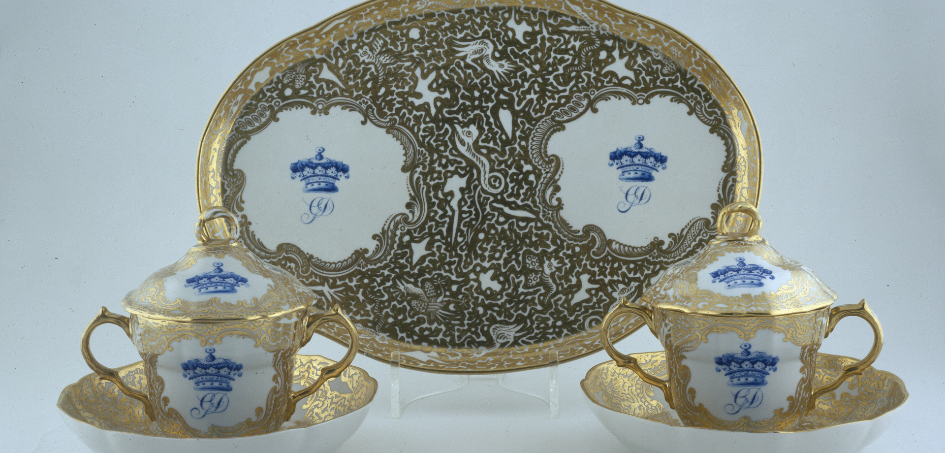 Derby caudle cups, covers, stands and an oval tray