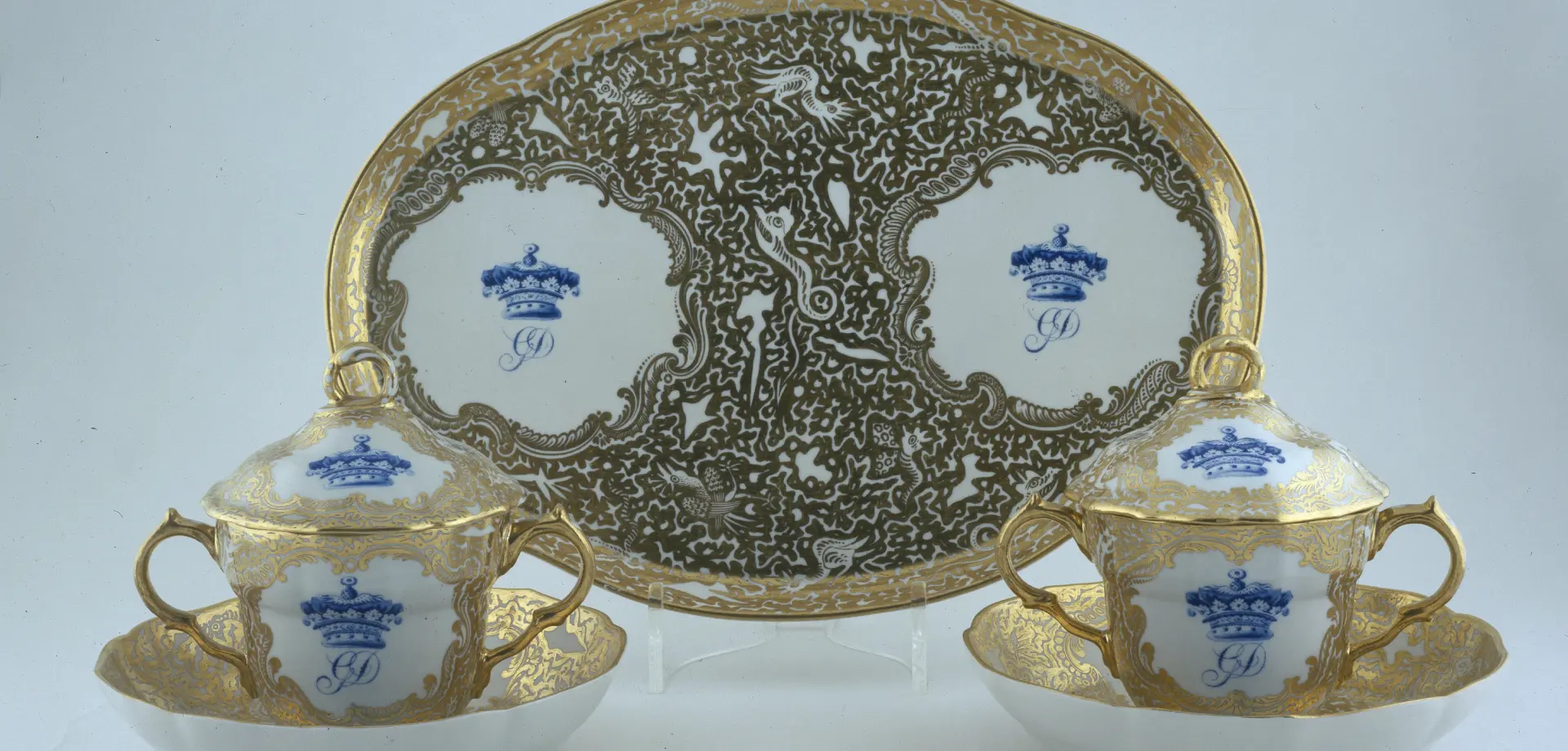 Derby caudle cups, covers, stands and an oval tray